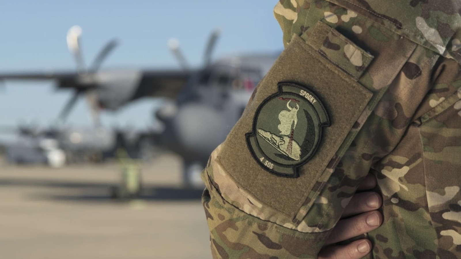 Air Force sensor operator near an AC-130J equipped with electro-optical and infrared sensors