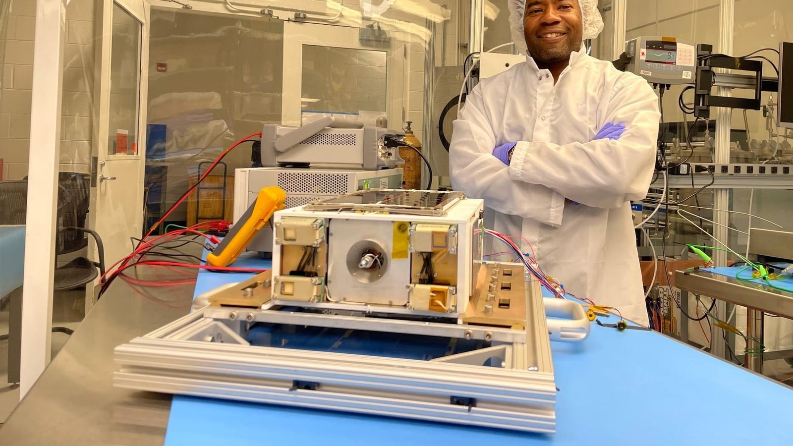 NASA project manager Nehemiah Williams preparing ASCENT Propulsion Dual Mode flight hardware for testing in a Marshall Space Flight Center clean room