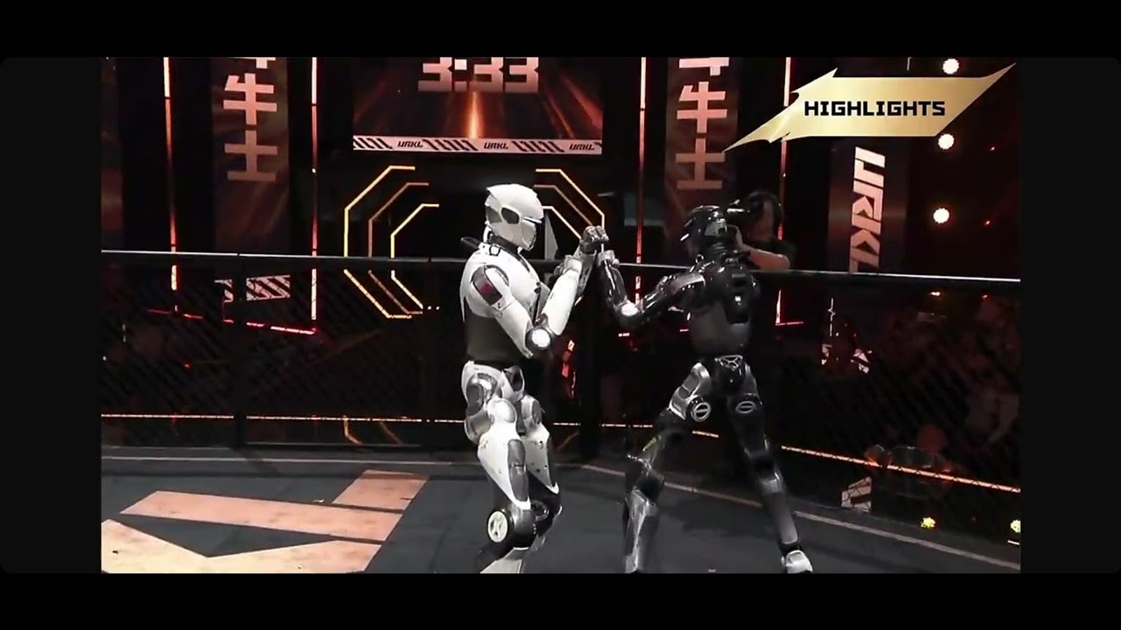 Two full-size humanoid robots exchanging strikes in the URKL opening match