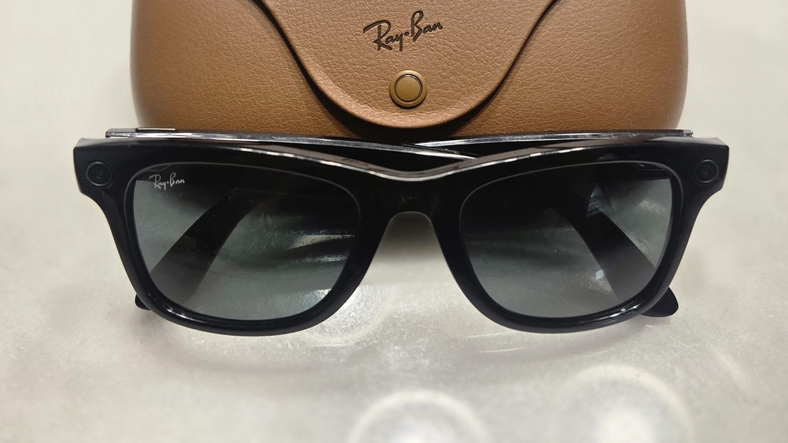 Ray-Ban Meta smart glasses positioned with their charging case