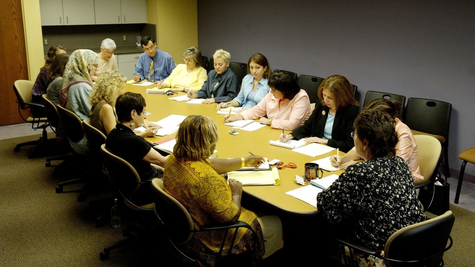 Cancer Information Service staff holding a working meeting around a conference table