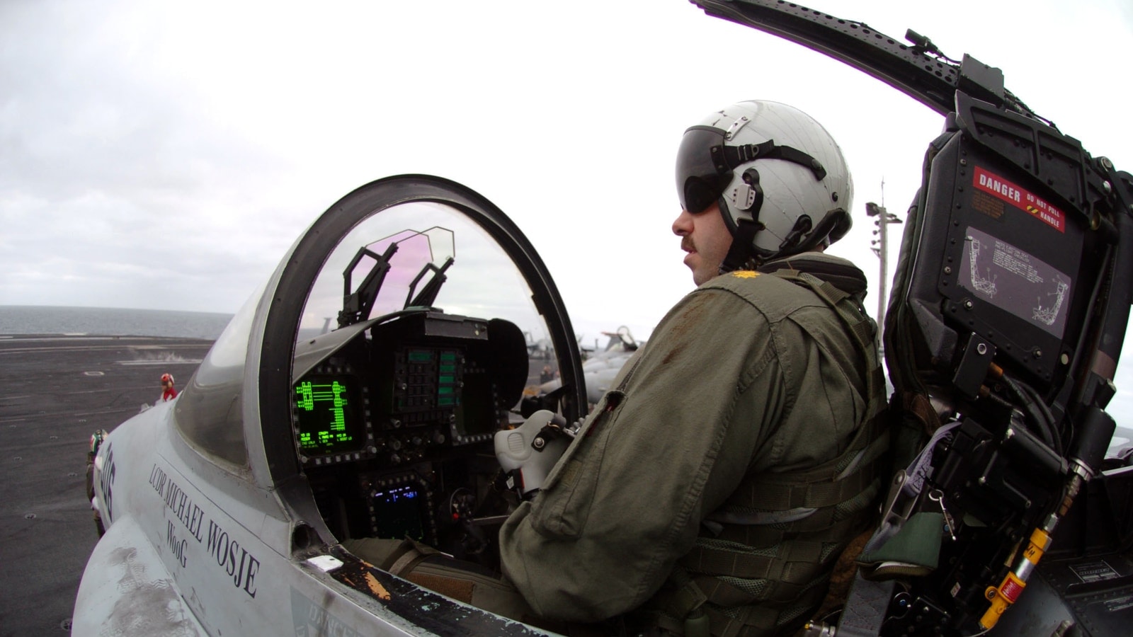 U.S. Navy F/A-18C pilot seated in the cockpit