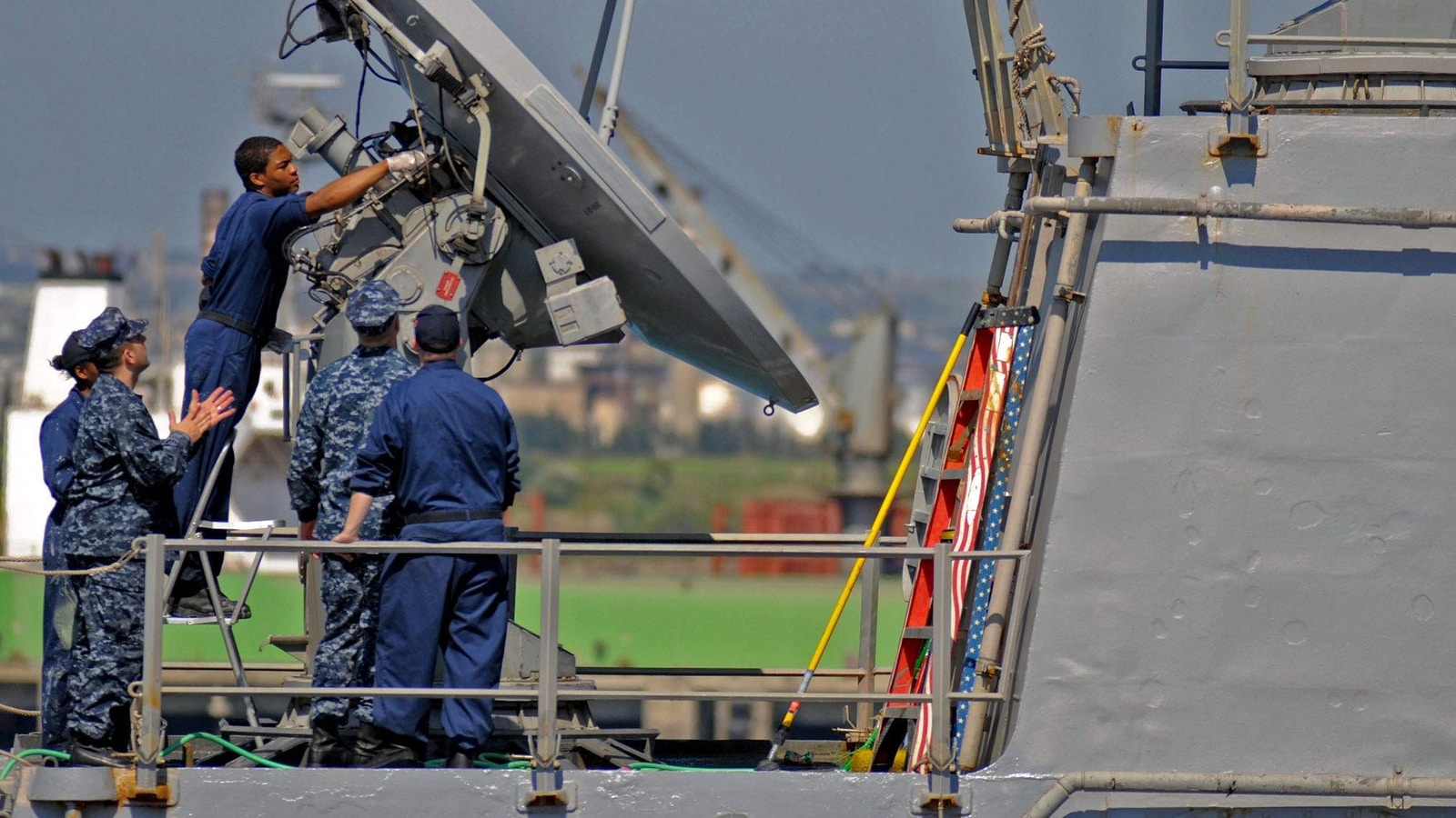U.S. Navy sailors maintaining an SPG-62 radar aboard USS Stout